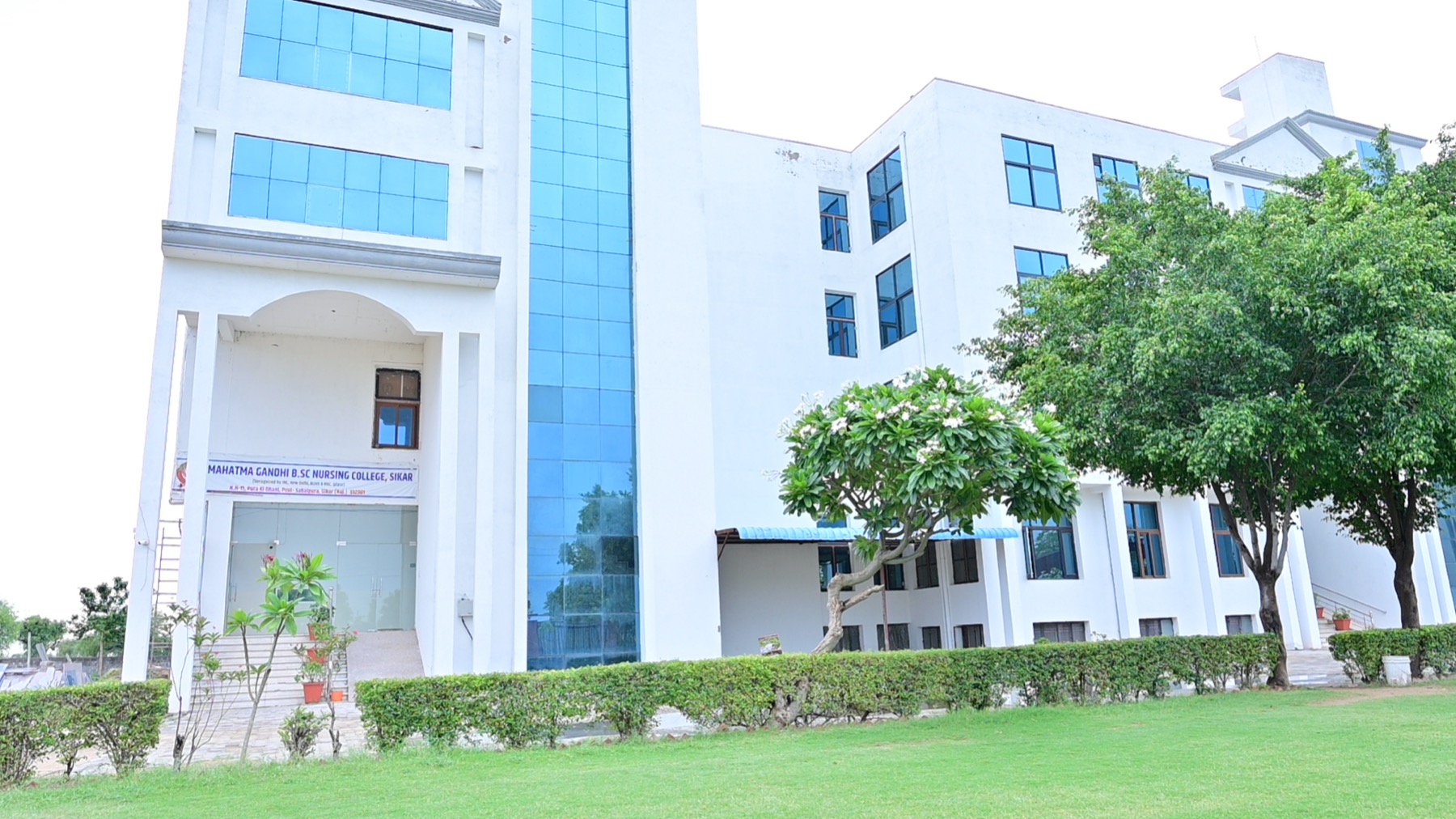 MGGC Sikar nursing college building and campus lawn photographed in July 2026