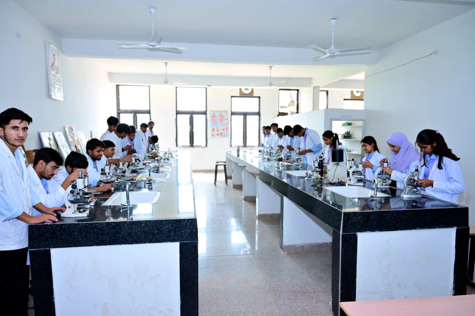 Students completing microscope work across the MGGC Sikar laboratory