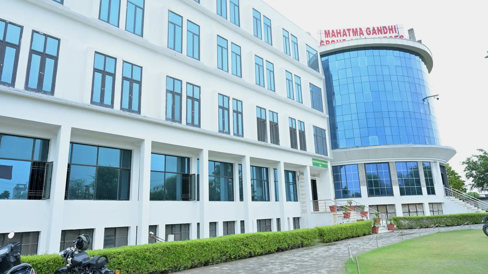 Blue-glass healthcare academic block at MGGC Sikar