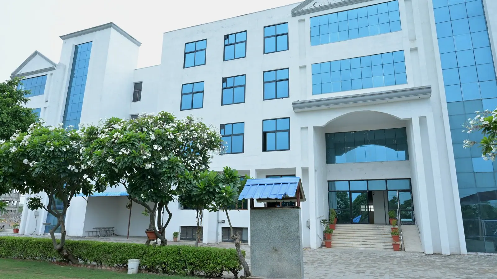 MGGC Sikar main academic building and front lawn photographed in July 2026