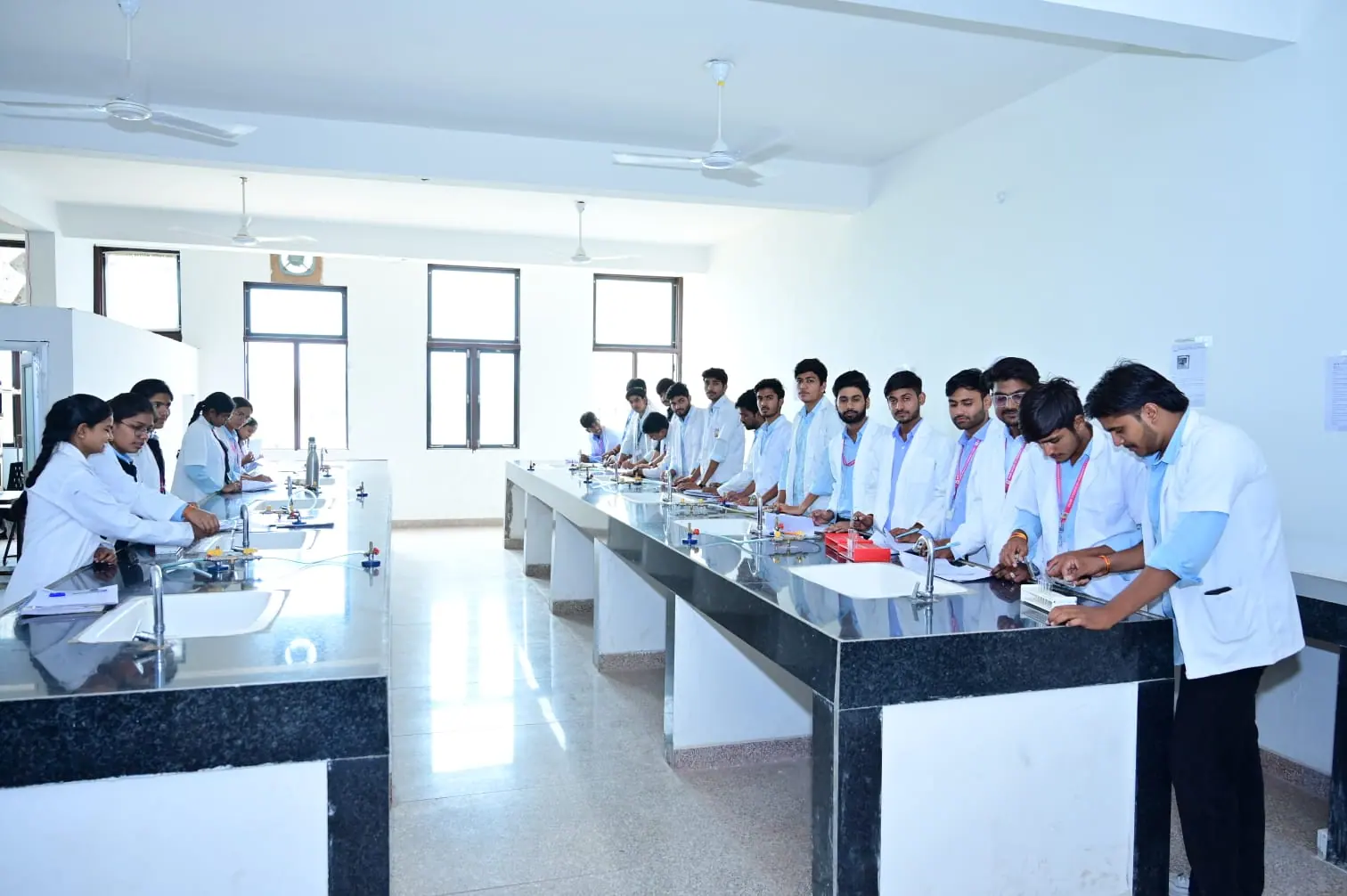 Students working across laboratory benches during an MGGC Sikar practical session